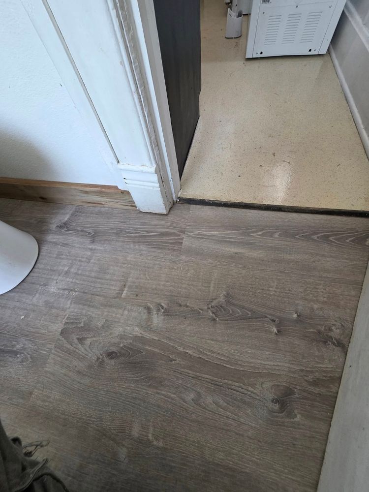 New luxury vinyl plank flooring installed at a doorway transition